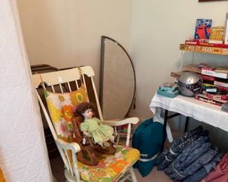 Rocker and vintage porcelain doll in wooden rocker, chair cusions and toys