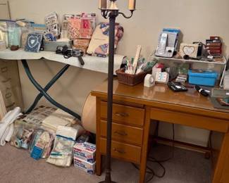 Small desk with office items, crafts and vintage floor lamp