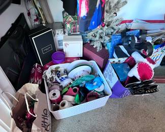 Assorted Christmas supplies such as, decorations, tissue paper, wrapping paper, ribbon, tape, Christmas boxes, tree + MORE