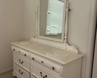 Chest of drawers in guest room. White. Mirror.