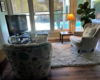 Wing back upholstered chairs with side tables and television and tv stand