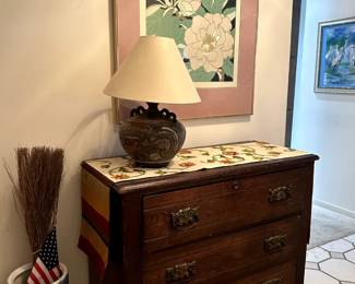 Chest with porcelain umbrella stand. Lamp. Paintings.