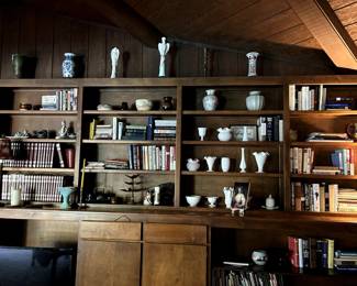 Books. Milk glass. Decorative statues, including a Lladro sculpture.