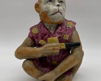 Majolica monkey figurine holding pipe