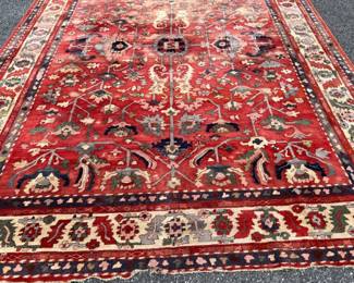 Large room size antique Turkish rug with wear; 107” x 139”