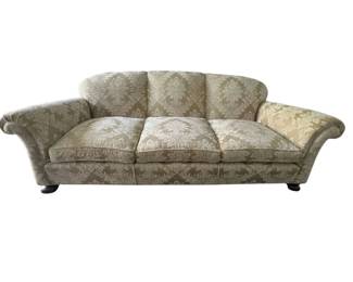 Custom upholstered champagne cut damask covered three cushion sofa
