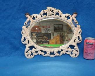 Lot 194. Oval shape beveled mirror in a cast-iron hand-painted frame. Frame appears to have been originally gold gilt.