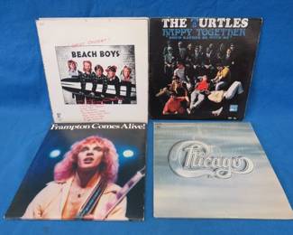 Lot 71. Twelve 45's and twelve 33's including Peter Frampton, Queen, Chicago, and more particularly