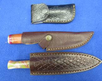 Lot 332. Three new Damascus knives with leather sheaths and no maker's mark