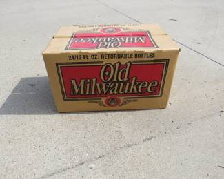 Lot 129. Old Milwaukee cardboard beer case with 18 home-brew bottles for re-filling. DO NOT DRINK