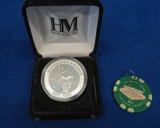 Lot 373. Minnesota Vikings silver-plated replica game coin from 2020 and a $25 Las Vegas High Roller Casino chip