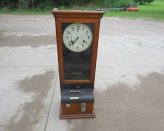Lot 13. Antique time clock in an oak case. Made by the Interboro Time Clock Co. Includes locking key, winding key, and pendulum. Untested.