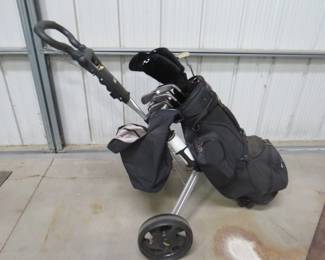 Lot 428. Set of Dunlop left-handed golf clubs with irons 3-PW, three metal woods, with a BagBoy pull-cart