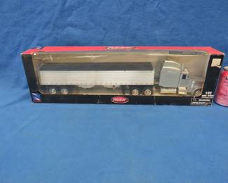 Lot 399. NewRay 1:32 scale die-cast Peterbilt with trailer. Never been out of the box.