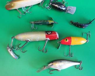 Lot 294. Bag O' Baits: Two wooden Bass-Orenos, one has glass eyes, and the other has tack eyes., Arbo Gaster, and more.
