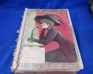 Lot 456. Large Victorian-era scrapbook filled with trade cards, postcards, and more. The back cover is separated from the binding