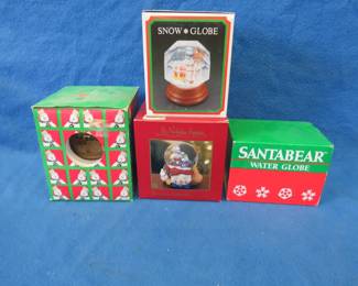 Lot 138. Four snow globes. One is a little cloudy. The other