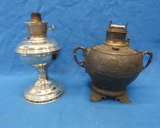 Lot 276. Two kerosene lamp bases. An Aladdin Model 11 and a double-handled base from an unknown maker. Feet have been repairedm but not well. 