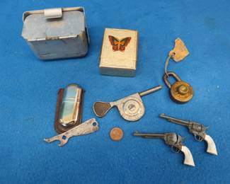 Lot 343. Collectible smalls including a Gay-Ola bottle opener, Marlboro lighter, Bait Baffler worm box, miniature non-working cap guns, and more