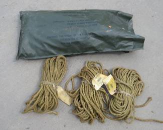 Lot 341. US Military tent peg bag with contents: 25 16" oak tent pegs. 14 23" oak tent pegs. One 18"steel pin. 15 lengths of 19' manila rope.