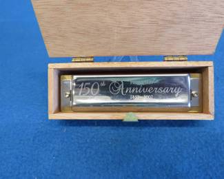 Lot 208. Hohner 150th Anniversary 1857-2007 diatonic harmonica with a solid acrylic comb and a wooden box. All in excellent condition