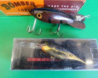 Lot 314. 2 1/2" Bomber in a box in excellent condition with papers marked 655. Rapala 2 1/7" Shad Rap Advertising Grand Casino 97 in the box.