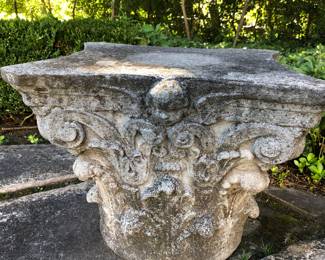 Antique cement Corinthian capital with cherub head 