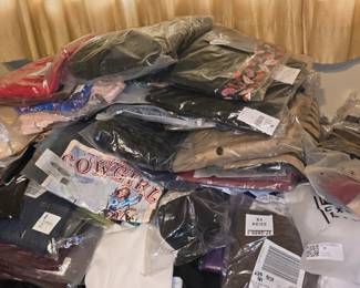 Big Pile of Brand New Shirts and Pants Still in Bags