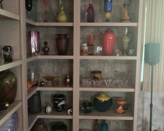Bookcase full  of colorful art glass including Moser, Orrefors, Daum, Lalique