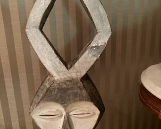 Carved wood mask on stand.  Is it a rabbit?