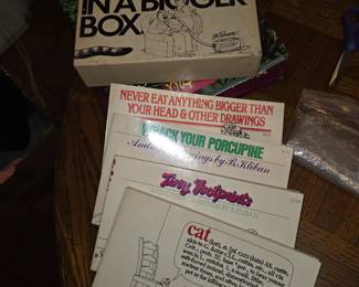 $10.  Four separate paperback books with Box
