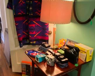 Santa Fe Long Wool Coat, Antique Parlor Table, Camera Collection