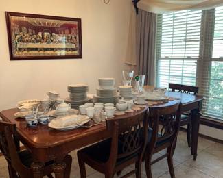 Antique dining table with matching hutch and buffet, vintage china