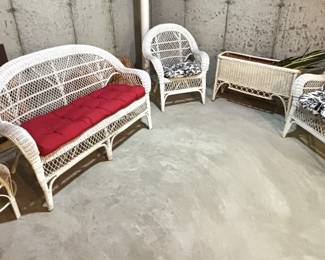 Wicker couch with cushion.     Pair of Wicker chairs with cushions. 