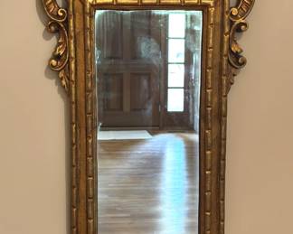 Gold framed mirror.