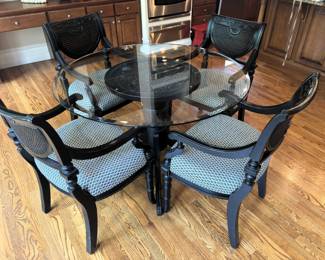 Heritage Dining Glass Top Carved Table Base Table with four cane back arm chairs.  