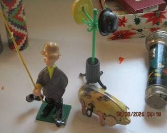 Tin wind up hog and a fisherman