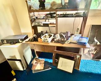 Telephones, answering machine, antennas, filing cabinet, desk, briefcase