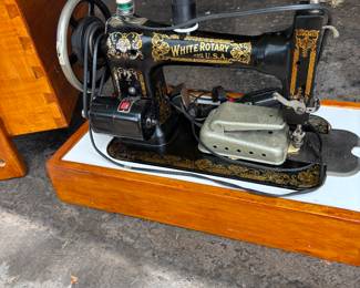 White rotary sewing machine in handcrafted wooden case