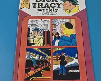"Dick Tracy Weekly" comic book, issue #28, published in 1988.
The comic features the well-known detective character, Dick Tracy, and the cover mentions "featuring JUNIOR and MODEL'S tragedy".
