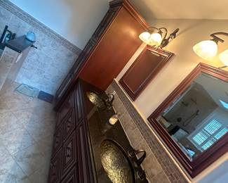 wood cabinets, vanity, mirrors, light fixtures, sinks