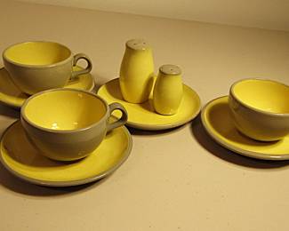 Three Harkerware cups and saucers with a small plate and two shakers