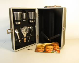 Vintage travel bar with cocktail recipes and key for lock