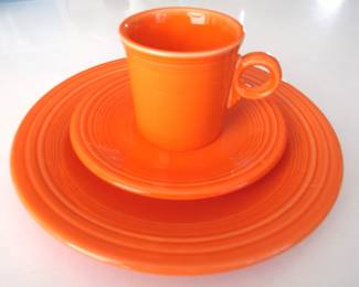 Three pieces of Fiestaware: dinner plate, salad plate, and mug. Tangerine color.