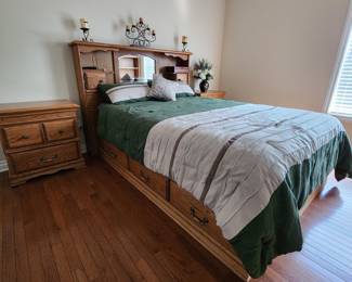 Great condition. Oak Bedroom Set with storage at the bottom (3 drawers on each side) and top (cabinets on headboard). Two Oak two drawer nightstands also included.