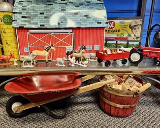 1950 Tin Litho Rolling Acres Farm by Ohio Art, +
Plastic Animals & Accessories for Barn, KC's Garage Tin Litho Sign, 1970's Ertl Red Metal Tractor & Cart, Radio Flyer Toy Wheel Barrow, Bushel Basket, & Vintage Wooden Learning Blocks
