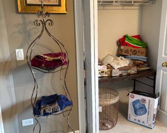 Decorative three tier wire, baskets, table, linens, odds, and ends