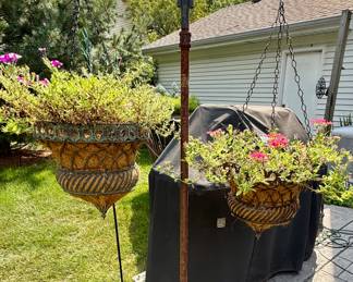 One of many Shepherd Hooks with Planters full of Plants