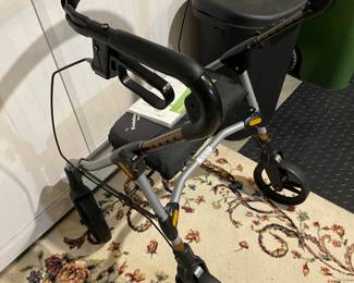 Walker with seat and four wheels