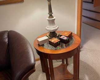 One of two round wood and glass side tables with great lamps, music boxes